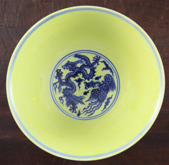 A Chinese yellow ground dragon and phoenix bowl, Xuande six character mark and possibly of the period, 19.5cm, museum restoration, sc